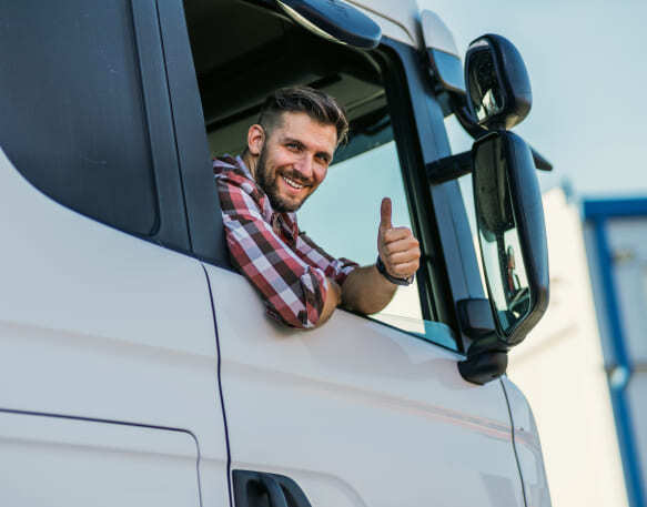 A truck driver leans out the window and gives a thumbs up.